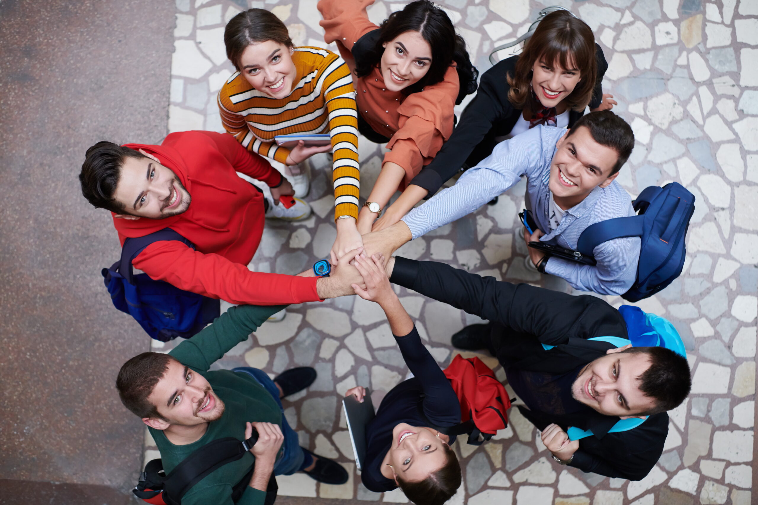 Group of happy young people showing their unity.